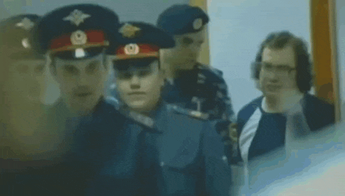 a group of police officers are standing next to each other in a line .