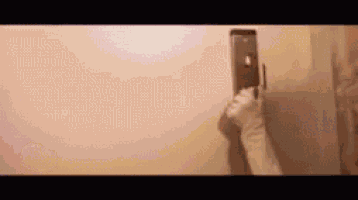 a person is taking a picture of themselves in a mirror with a cell phone .