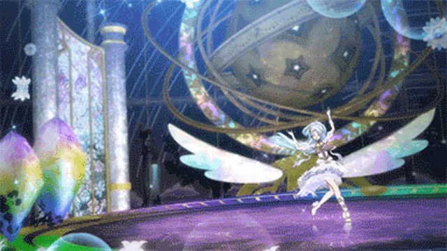 a girl with wings is dancing on a stage in front of a large sphere
