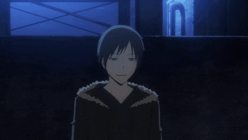a man in a black jacket stands in the dark