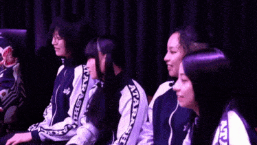 a group of girls wearing matching jackets with the word atari on the side