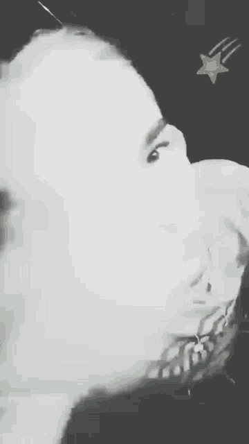 a black and white photo of a person with a star in the background