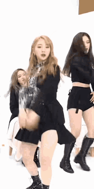 a group of young women are dancing on a stage .