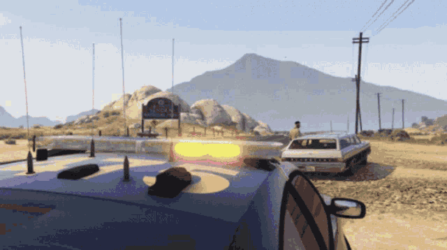 a video game scene with a police car and a sign that says california