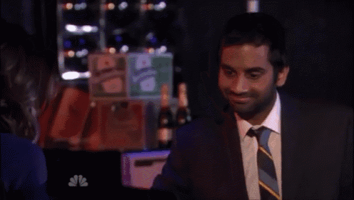 a man in a suit and tie is looking at the camera