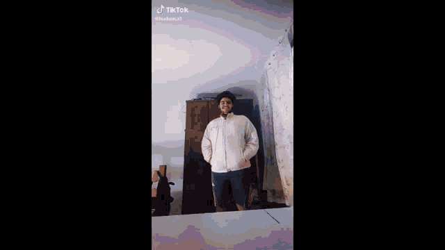 a blurry picture of a person standing in front of a window .