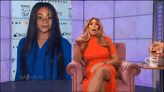 wendy 10 sits in a chair in front of a screen with a picture of her on it
