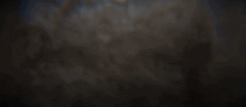 a man is digging a hole with a shovel in the dark