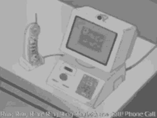 a black and white drawing of a computer with a telephone attached to it