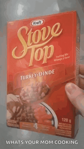 a person is holding a box of stove top stuffing in turkey .