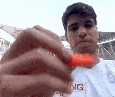 a man wearing a white shirt that says ng