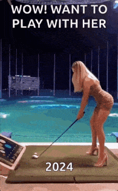 a woman in a dress is swinging a golf club on a mat .