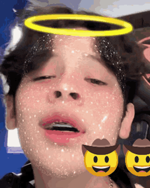 a close up of a person 's face with a cowboy hat and smiley faces on it