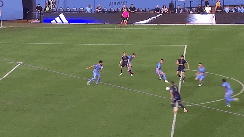 a soccer game is being played in front of a wall with etihad airways written on it