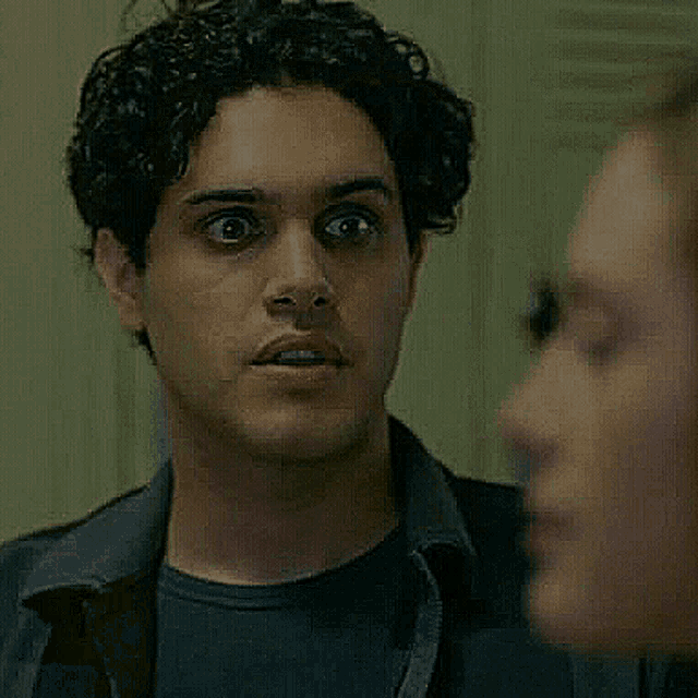 a close up of a man looking at a woman 's face