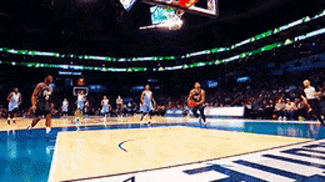 a basketball game is being played in a stadium with a sign that says ' allianz '