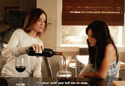 a woman pouring wine into another woman 's glass with the words " i 'll pour until you tell me to stop " visible