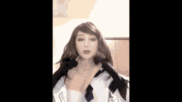 a woman wearing a wig and gloves is standing in a room .