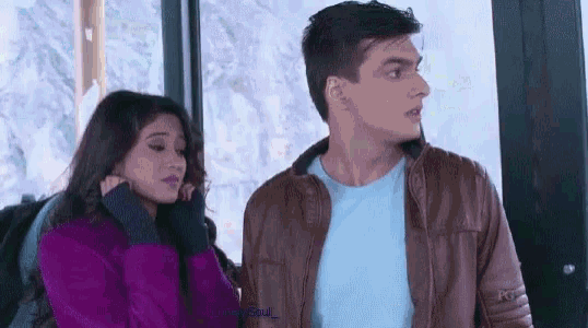 a man and a woman are standing next to each other and the man is wearing a leather jacket .