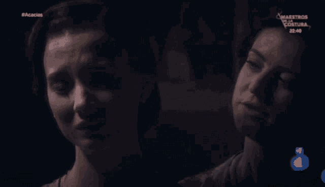 two women are crying in a dark room with the number 1 on the bottom right