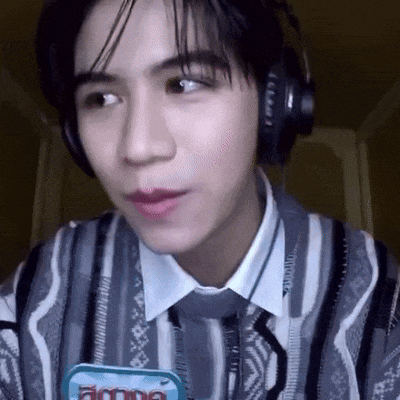 a close up of a person wearing headphones and a striped shirt .