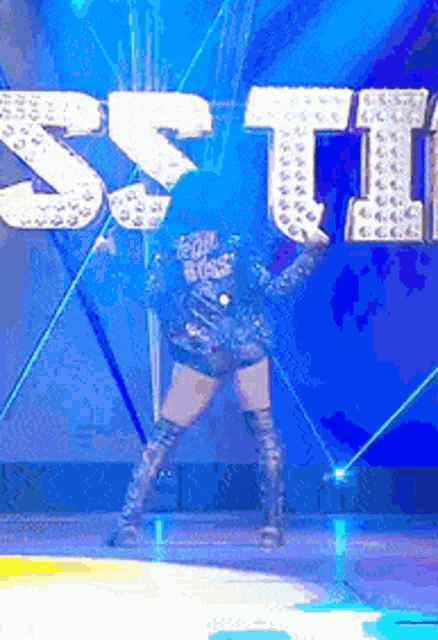 a woman is dancing in front of a sign that says ' star ' on it