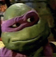 a close up of a teenage mutant ninja turtle 's face with a purple mask .