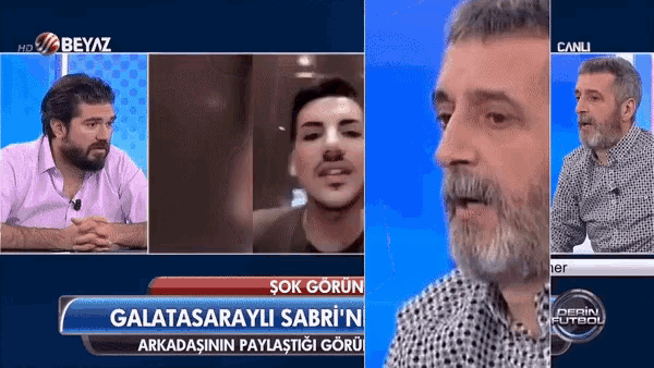 a man with a beard is talking on a tv show