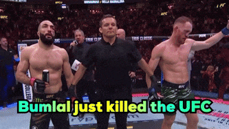 a referee stands between two fighters with the words bumlal just killed the ufc above them