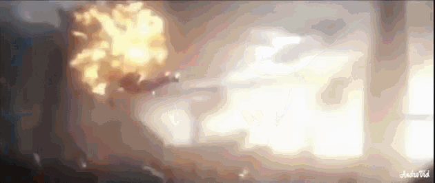 a man is flying through the air with a huge explosion behind him .