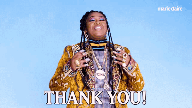 a woman wearing a yellow jacket and necklace says thank you