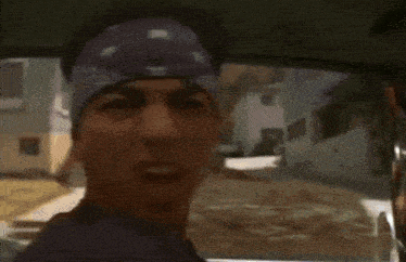 a man in a bandana talks to another man in a car with the words i don t wanna go to hospital