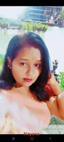 a woman taking a selfie with the name nayana on the bottom right