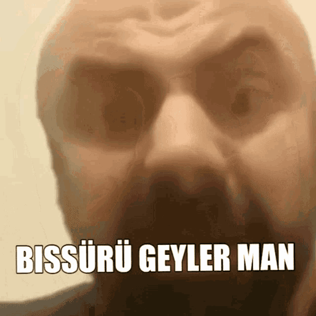 a close up of a man 's face with the words bissuru geyler man written on it