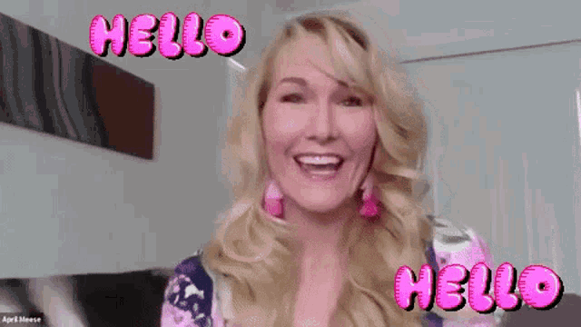 a woman with blonde hair is smiling and says hello