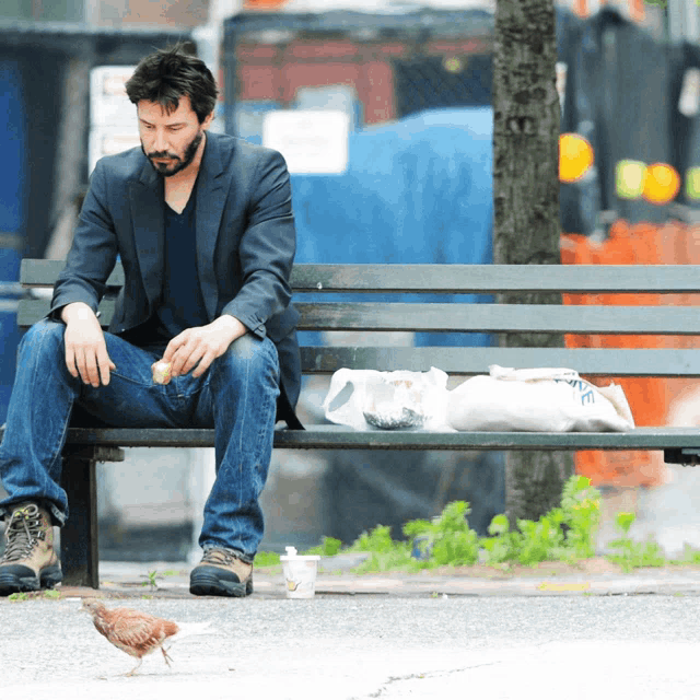 a man sits on a park bench with a cup of coffee and a bag of food
