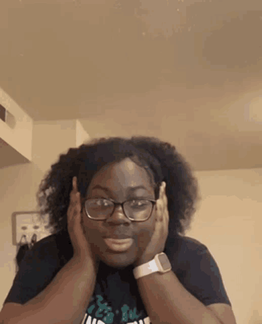 a woman wearing glasses and a watch is making a face .