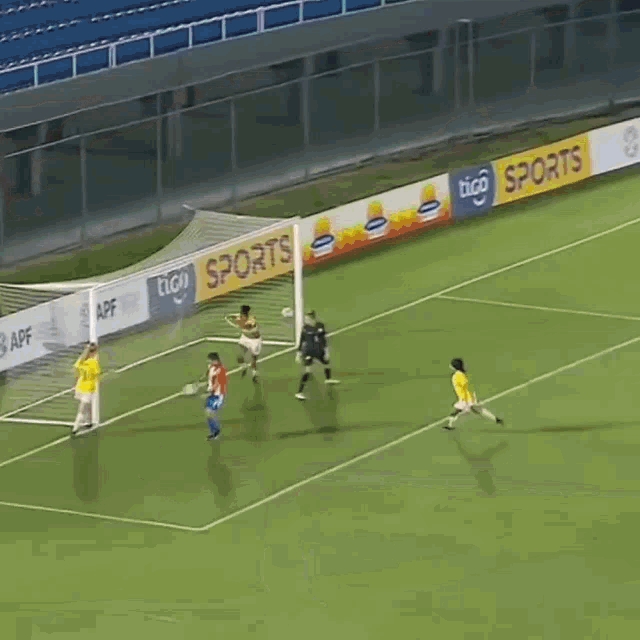 a soccer game is being played on a field sponsored by tico