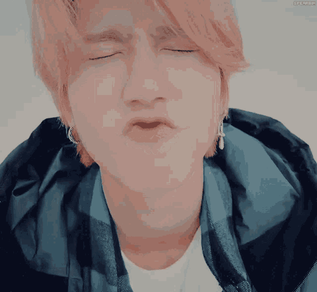 a close up of a person making a funny face with their eyes closed and the words speaker on the bottom right