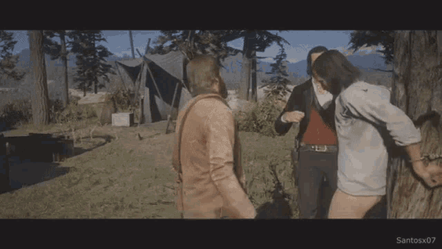 a man in a cowboy hat is holding a knife and talking to another man .