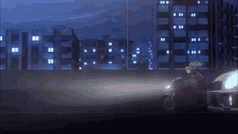 a person is riding a motorcycle down a road at night