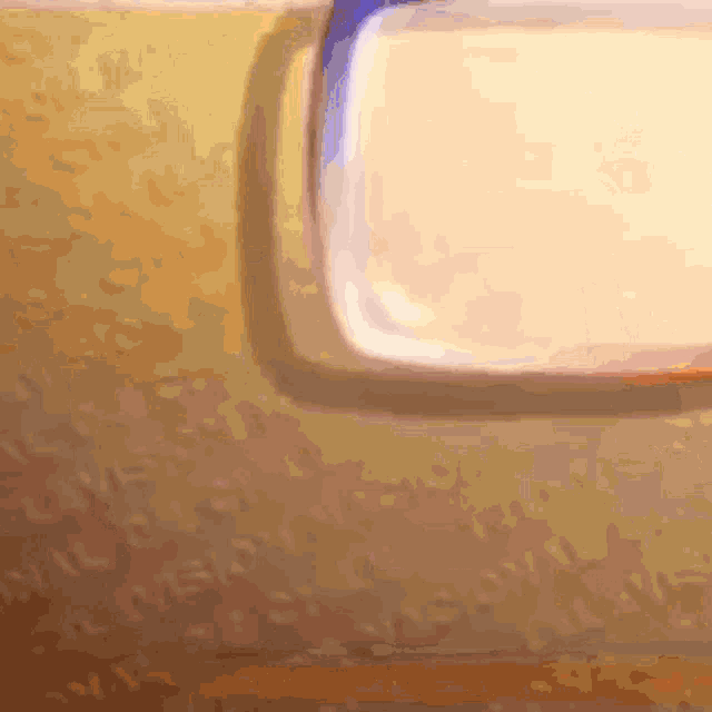 a close up of a yellow wall with the word television written on it