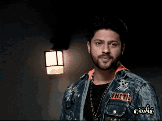 a man wearing a denim jacket with the word thrift on the sleeve