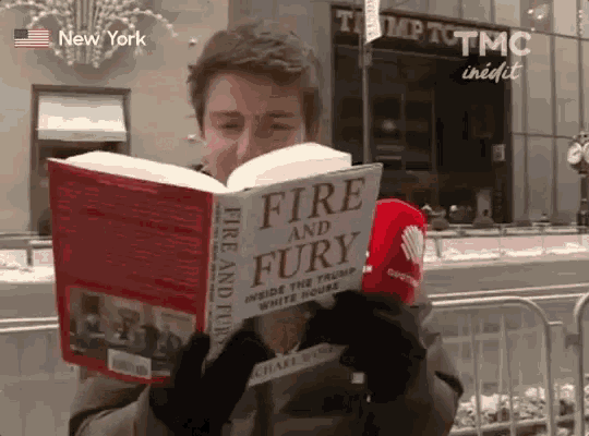 a man reads a book titled fire and fury