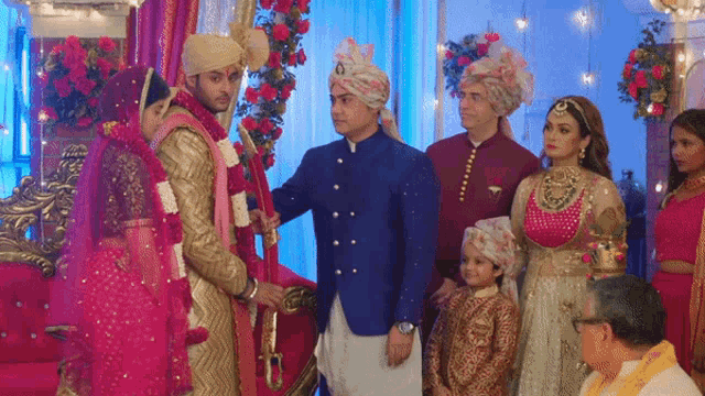 a bride and groom are posing for a picture with their family at a wedding