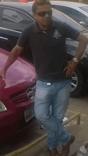 a man wearing sunglasses and a shirt that says lacoste on it