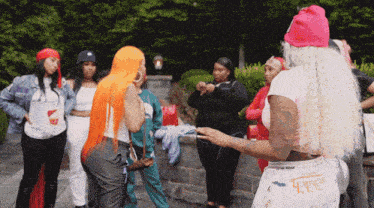 a woman wearing a pink beanie stands in a crowd of women