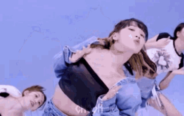 a group of women are dancing together in a blue sky .