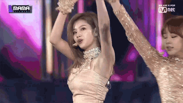 a woman is dancing on a stage with a sign that says mama