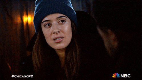 a woman wearing a blue beanie looks at a man with the hashtag #chicagopd on the bottom